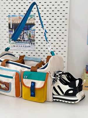Vibrant multi-pocket nylon travel bag with color block details and a blue strap.