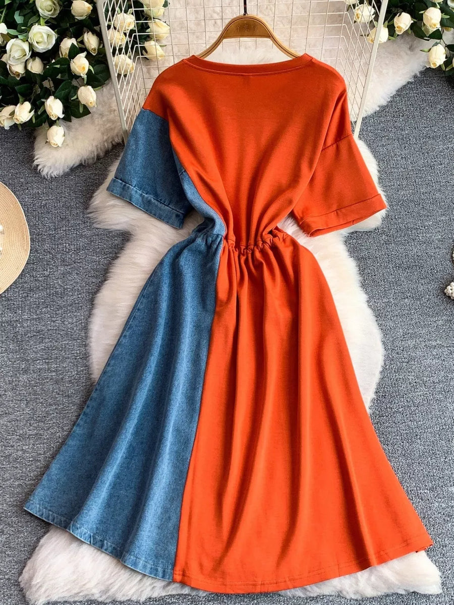Color block casual dress with orange and denim panels, drawstring waist.