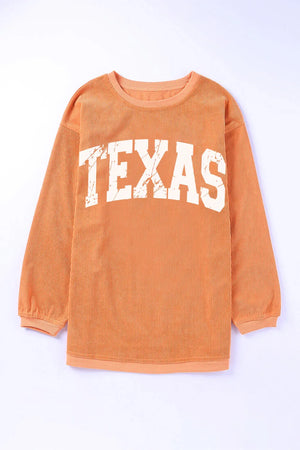 Textured sherbet crewneck sweatshirt with white "TEXAS" graphic and ribbed long sleeves.