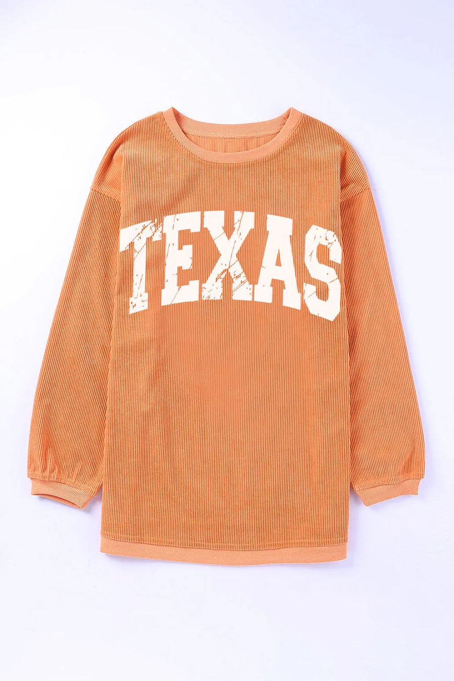Textured sherbet crewneck sweatshirt with white "TEXAS" graphic and ribbed long sleeves.