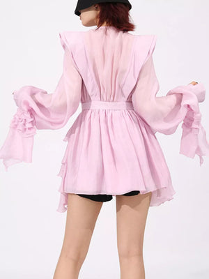 Pink tiered ruffle mini dress with long bell sleeves and a belted waist.