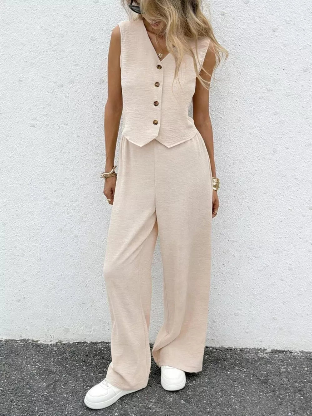 Chic beige button-down vest and flowing wide-leg pants set for women.