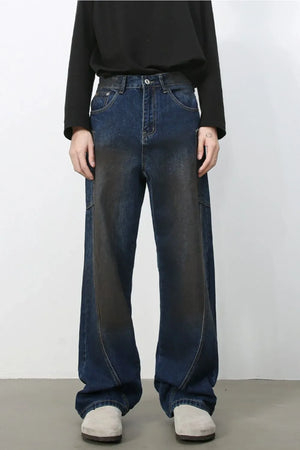 Faded panel wide-leg denim trousers in medium wash with a relaxed fit.