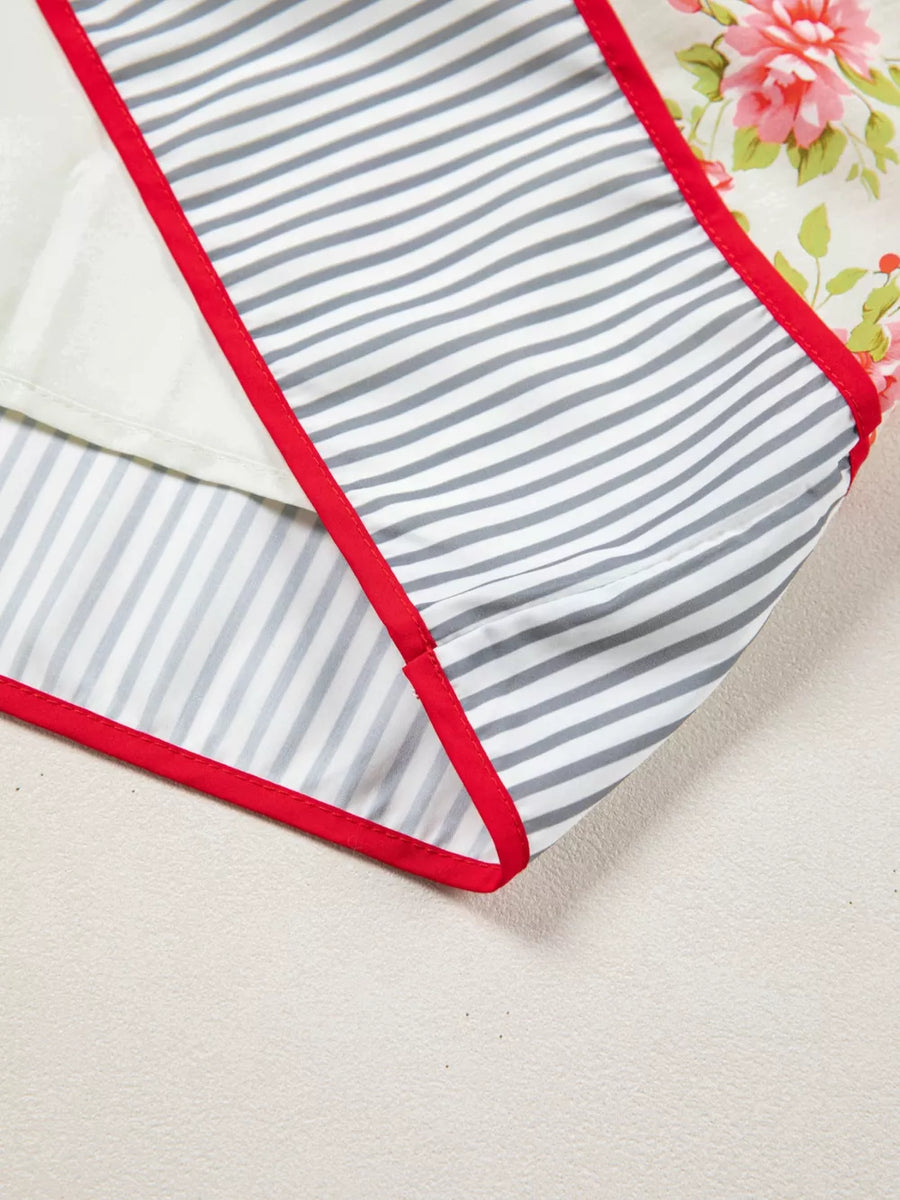 Floral cotton dress detail with red trim, grey stripes, and white lining.