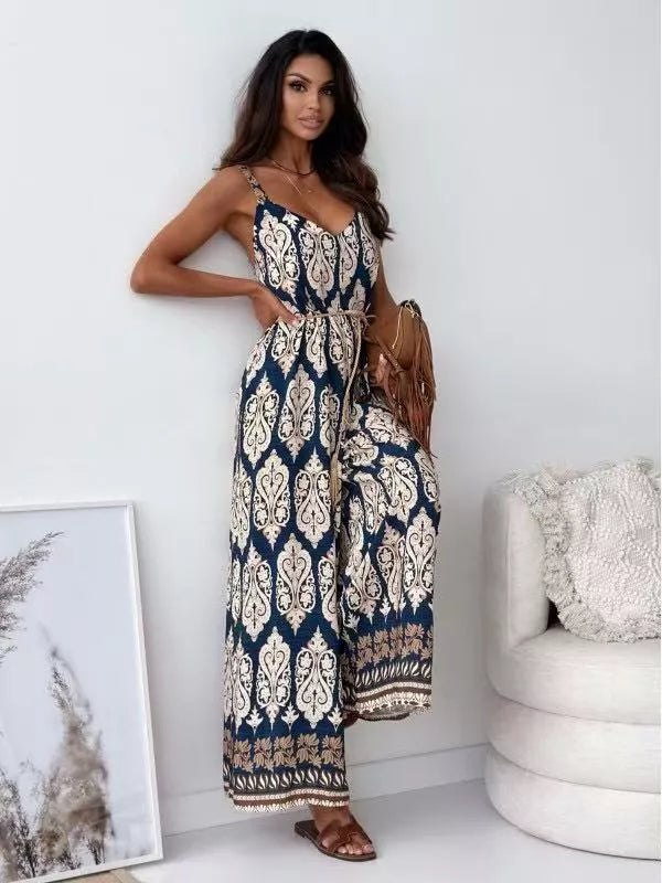 Peacock blue paisley romper with tie waist and wide legs.