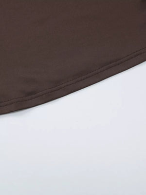 Brown halter crop top hem detail with double stitching.