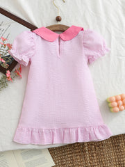 Pink seersucker baby dress with puff sleeves, Peter Pan collar, and ruffled hem.