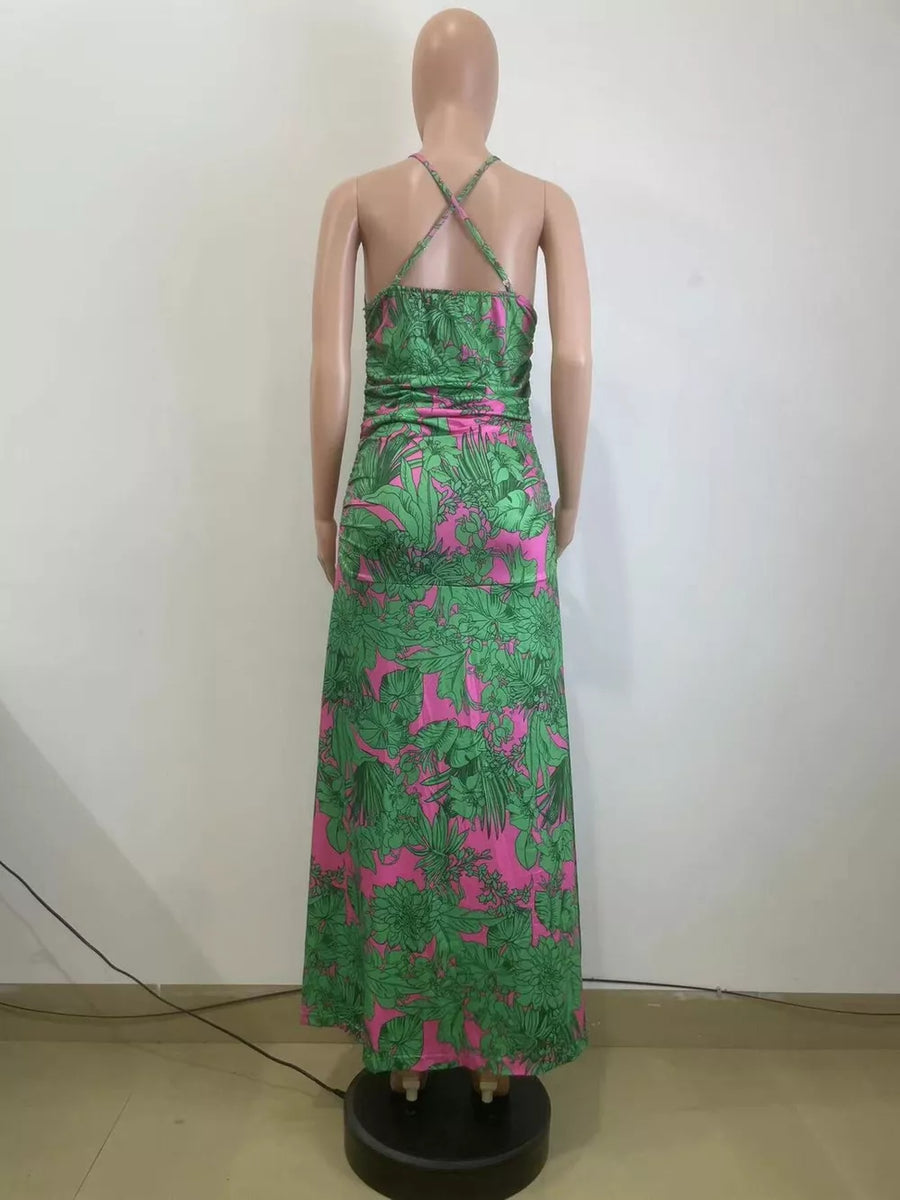 Tropical floral ruched maxi dress with criss-cross straps and a pink and green pattern.