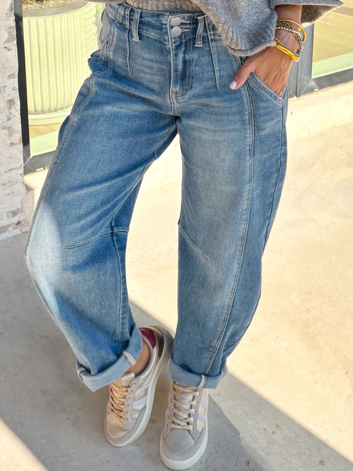 High-waisted light wash denim barrel jeans with cuffed hems and a relaxed fit.