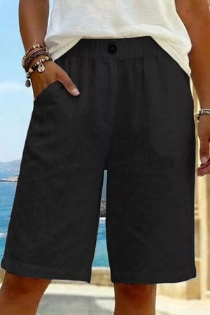 Black pocketed knee-length shorts with elastic waist and button detail