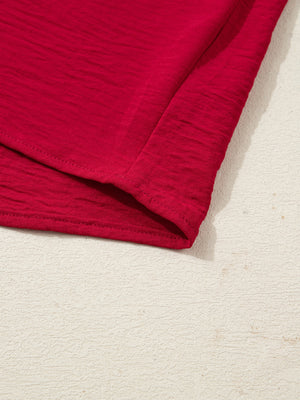 Deep red braided V-neck blouse with textured fabric and half sleeves.