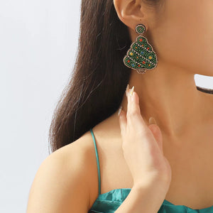 Festive tree dangle earrings in dark green with beaded details and crystal accents.