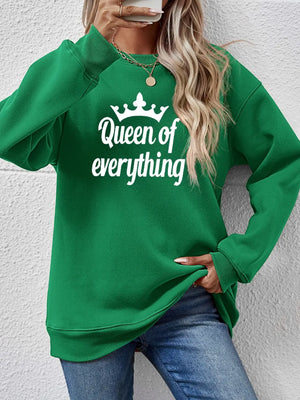 Green graphic sweatshirt with white Queen of Everything text and crown detail
