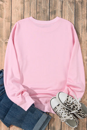 Blush pink crewneck sweatshirt with long sleeves and a relaxed fit.
