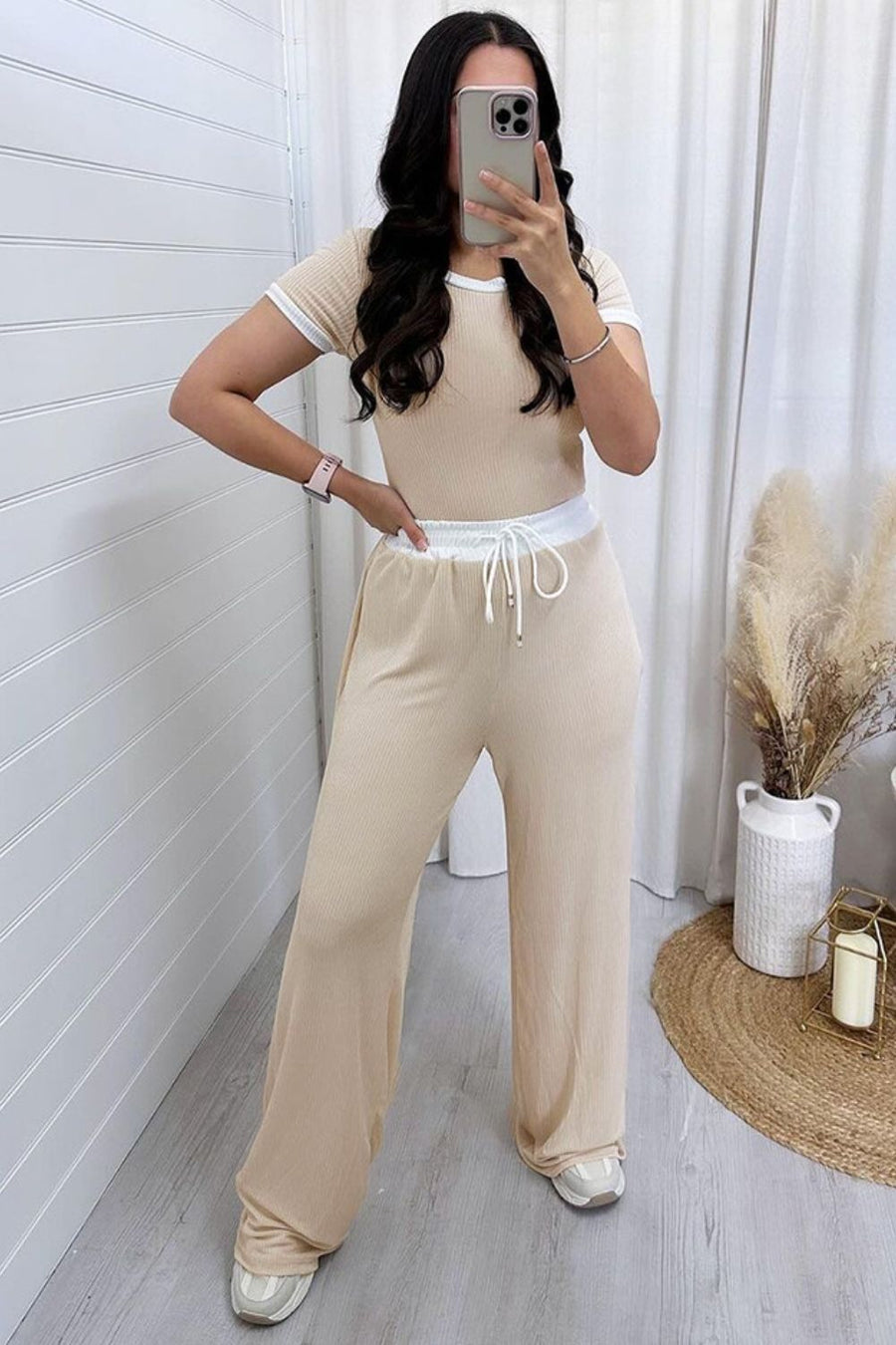 Tan ribbed loungewear set with contrast trim on the top and drawstring waist pants.