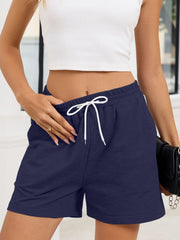Navy heathered jogger shorts with white drawstring and sporty trim detail.