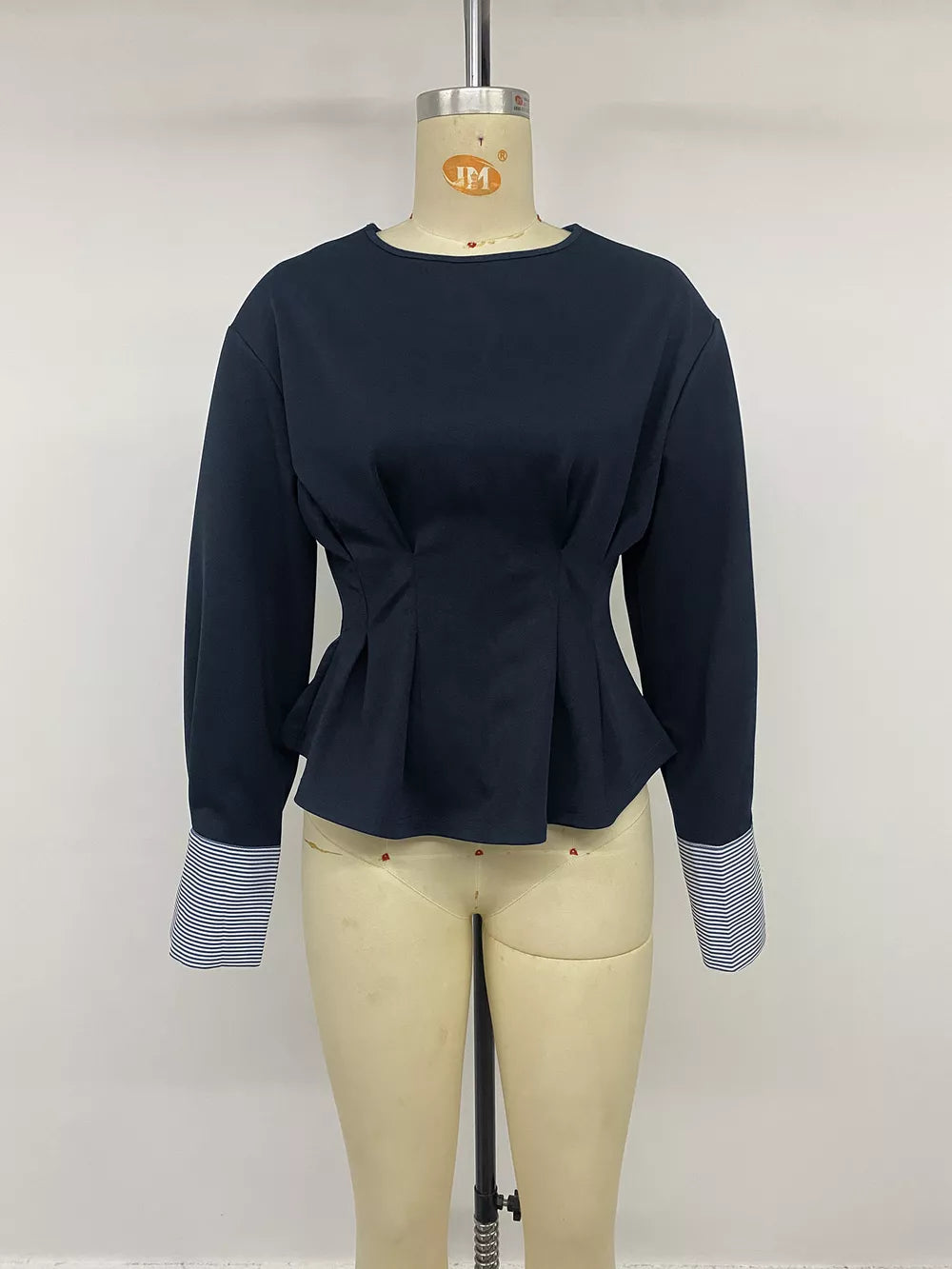 Round Neck Peplum Top With Striped Cuffs in navy blue with buttoned cuffs