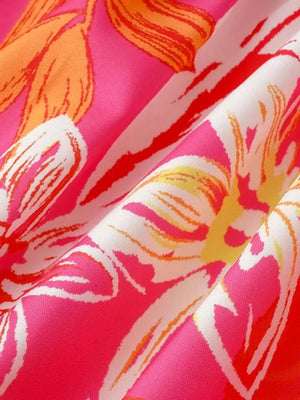 Tropical tie-strap smocked midi dress in strawberry pink with a bold floral print.
