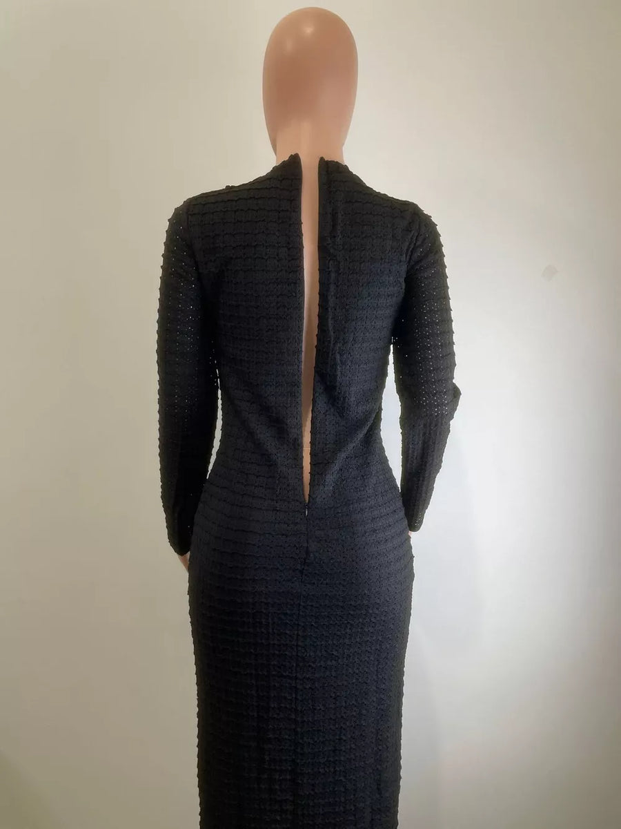 Black textured midi dress with long sleeves, crew neck, and decorative buttons down the back.