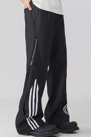 Black wide-leg sweatpants with side zipper, white stripes and graphic detail.