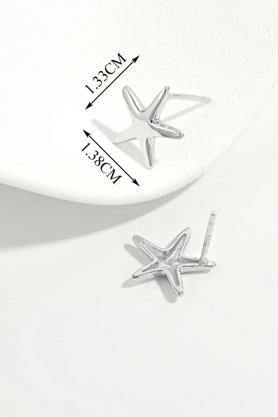 Silver starfish stud earrings with detailed measurements shown.