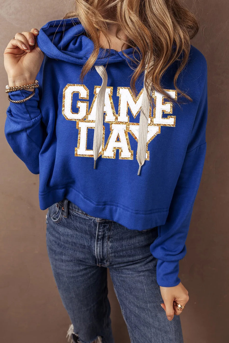 Royal blue cropped hoodie with glitter "GAME DAY" graphic and adjustable drawstring hood.