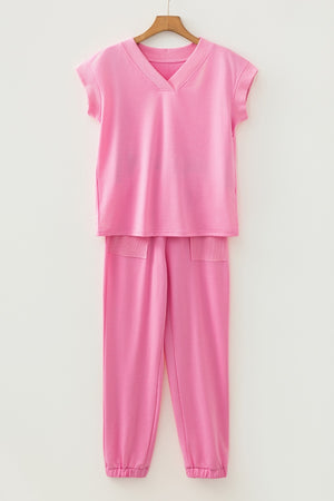 Pink cotton loungewear set with V-neck top and drawstring pants with pockets.