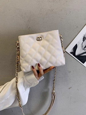 White quilted pu leather crossbody bag with gold chain strap and clasp detail