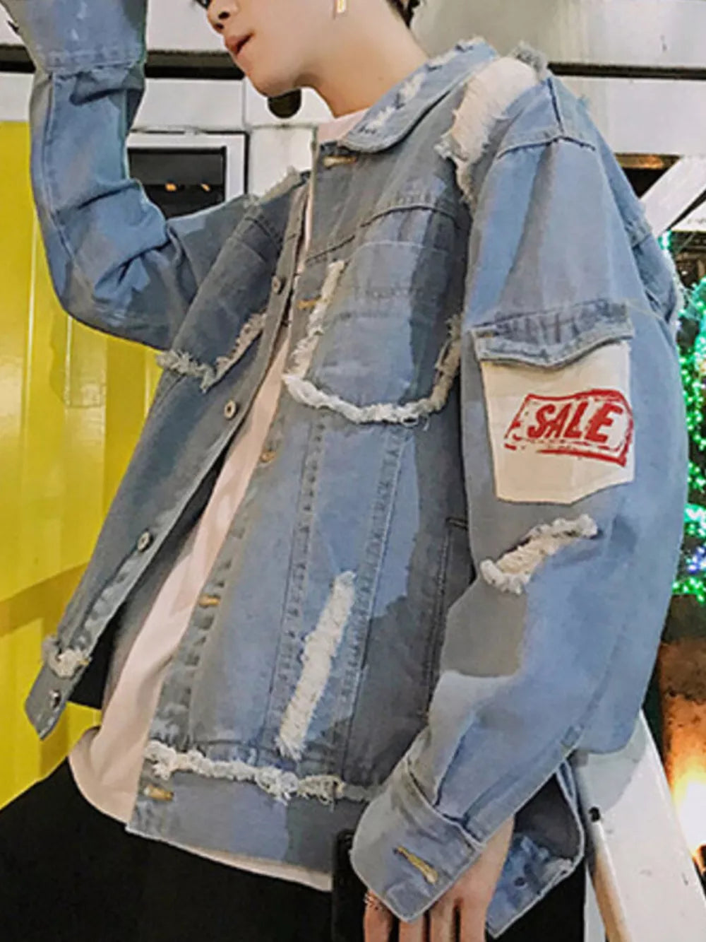 Men's light wash distressed denim trucker jacket with frayed details and a red SALE patch.