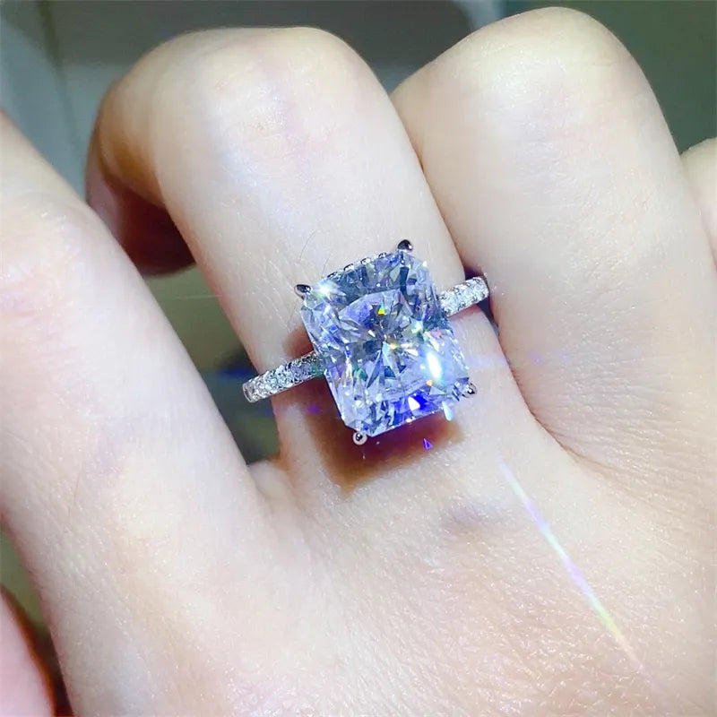 Radiant cut moissanite ring with pavé band in silver.