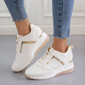 White lace-up wedge sneakers with metallic accents and perforated details.