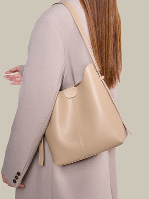 handbag in light beige featuring adjustable straps and soft structured fit