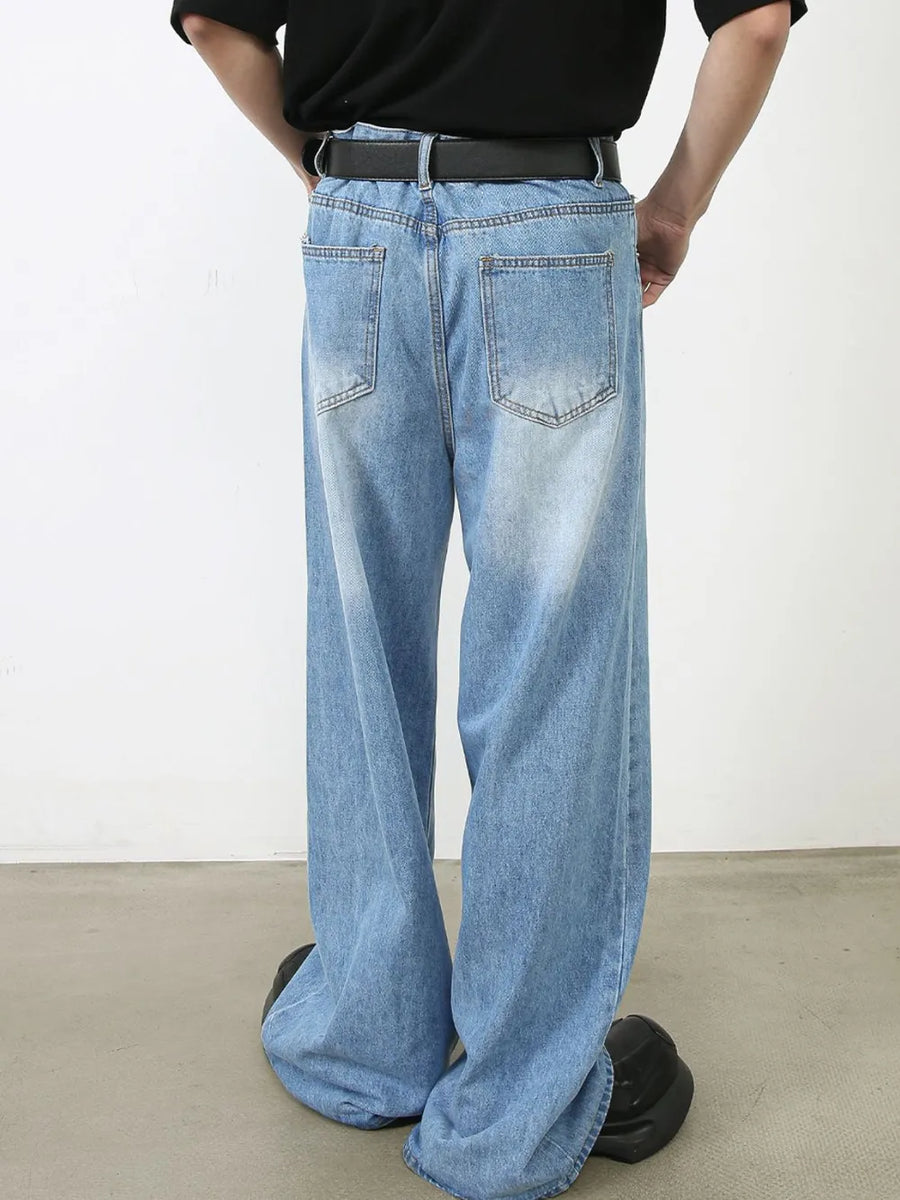 Light blue denim palazzo jeans with a wide leg and pleated front detail.