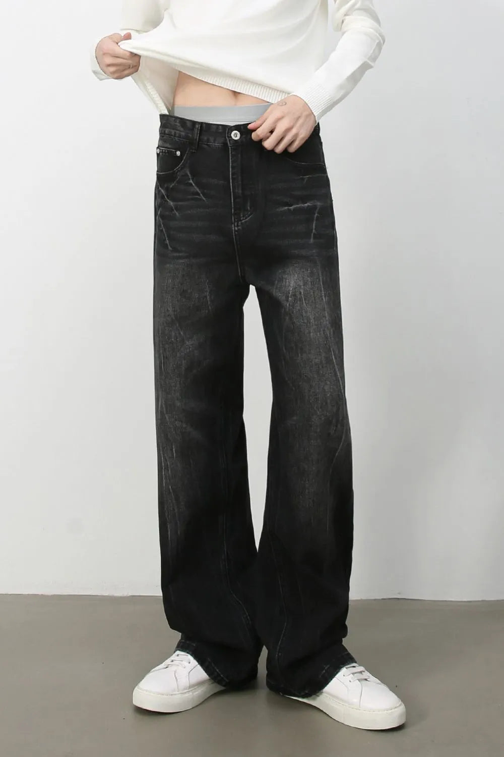 Wide-leg distressed denim jeans in dark vintage wash with a relaxed fit.