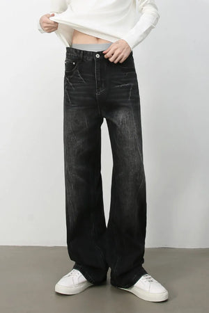 Wide-leg distressed denim jeans in dark vintage wash with a relaxed fit.