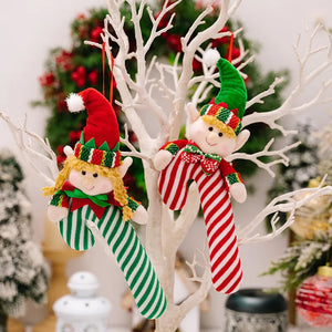 Elf cane holiday ornaments in red and green stripes with cheerful faces and hats.