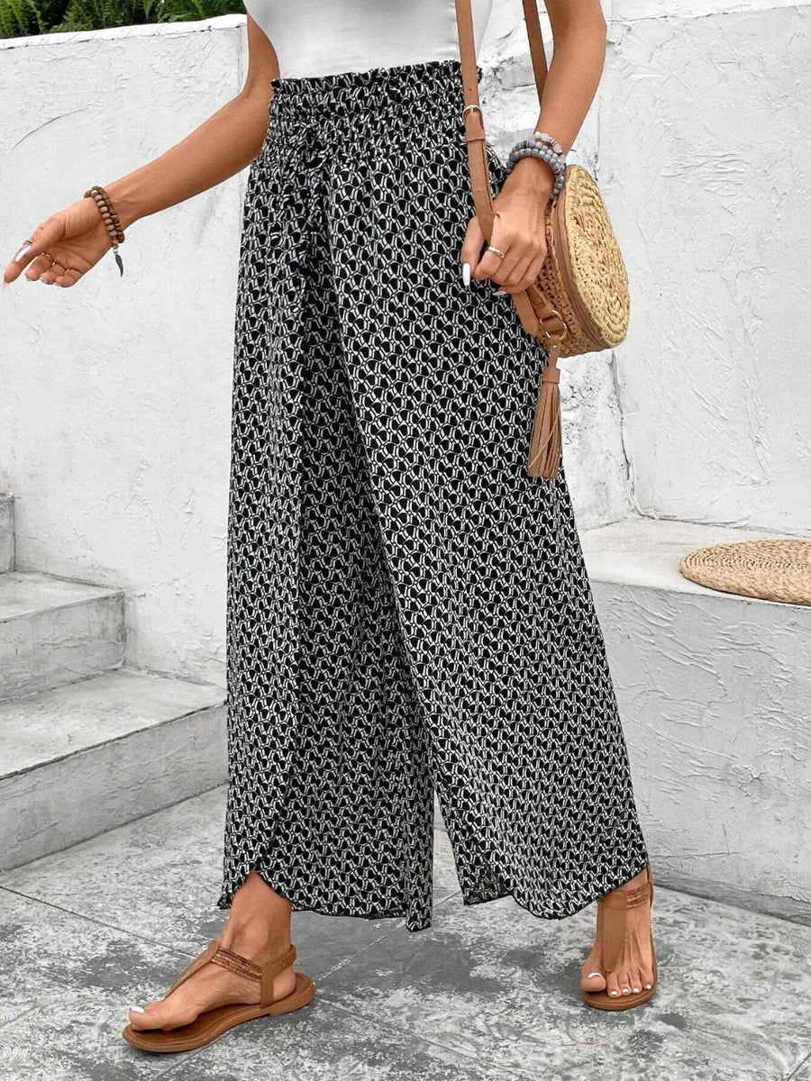 Black and white patterned palazzo pants with a drawstring waist and wide leg.