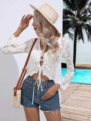 White lace-inset tie-front cardigan with keyhole neckline and bell sleeves, styled as a beach cover-up.