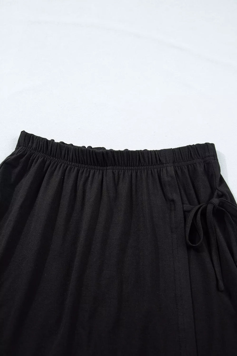Black tie-wrap two-piece ensemble with elastic waistband and drawstring detail