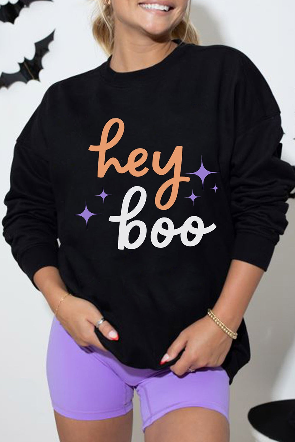 light orange sweatshirt featuring ribbed cuffs and graphic-print