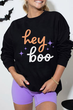light orange sweatshirt featuring ribbed cuffs and graphic-print