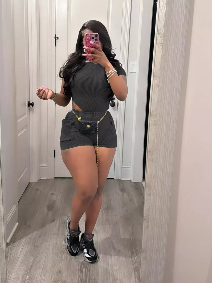 Black ribbed crop top and shorts set with pockets and chain belt detail.
