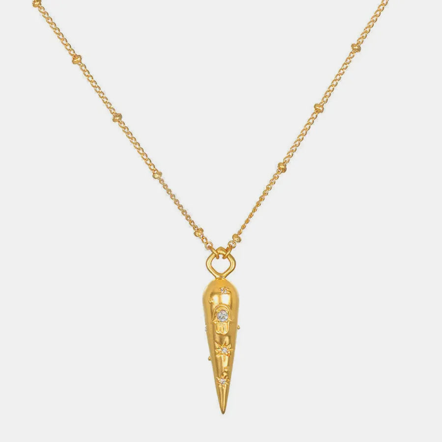 Gold layered necklace with beaded chain and conical pendant featuring celestial charms.