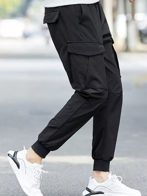 Black cargo joggers with adjustable waist and multiple pockets, cuffed ankles.