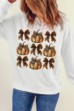 White sweatshirt with a watercolor print of pumpkins and leopard print bows.