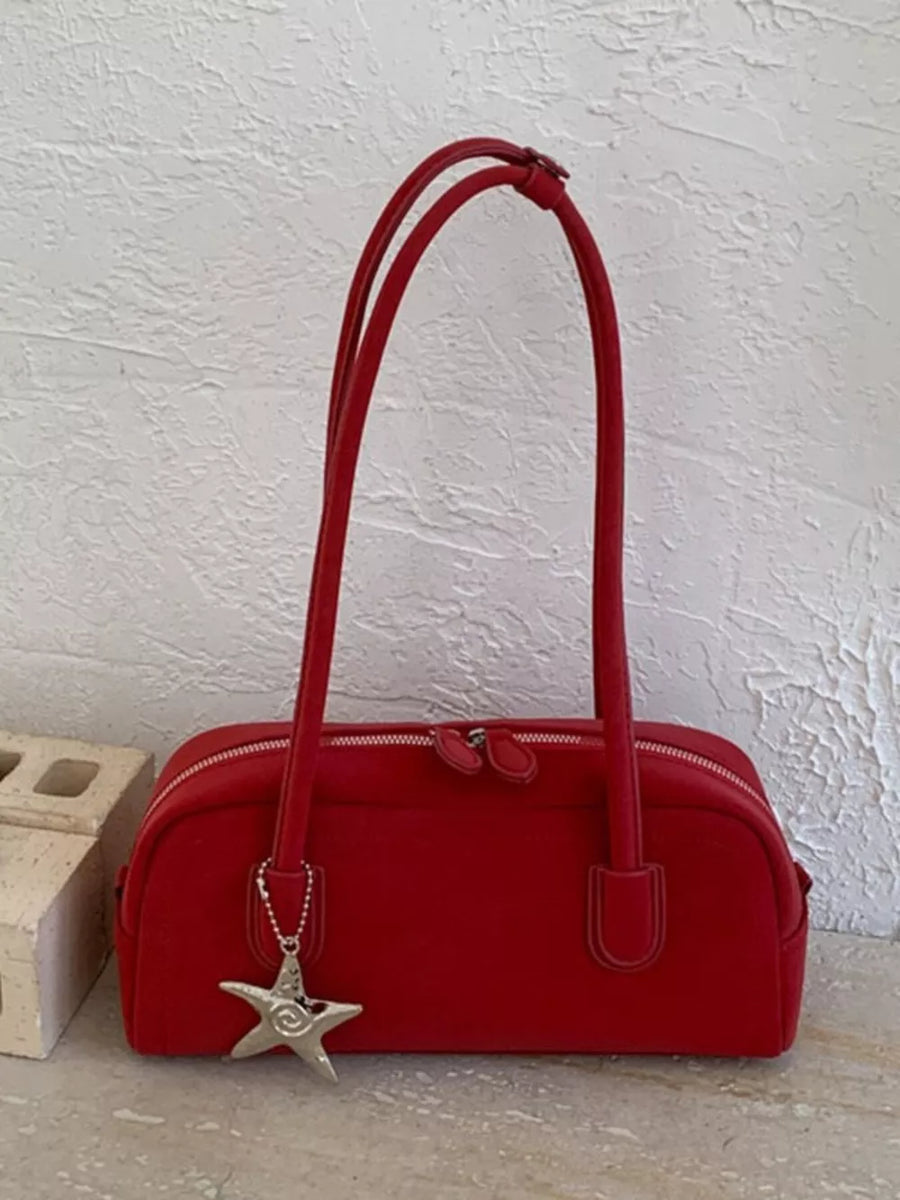 Red shoulder bag with star charm and double zipper closure