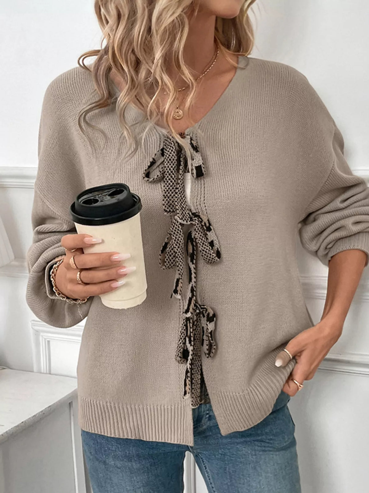 Gray knit cardigan with tie-front detail and snake print trim.