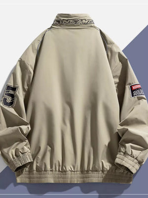 Beige bomber jacket with embroidered patches and text on collar