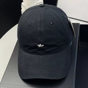 Black cotton baseball cap with embroidered alligator detail and ventilation eyelets.