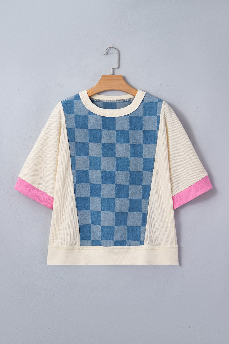 Maternity t-shirt with blue checkered denim panel, cream waffle knit, and pink sleeve cuffs.